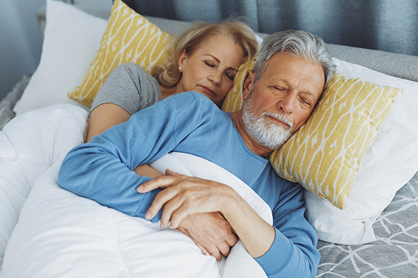 Senior couple sleeping peacefully in bed
