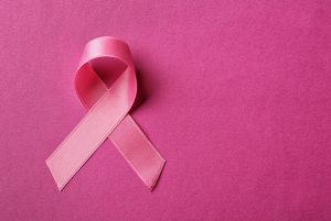 Pink ribbon for breast cancer on a pink background