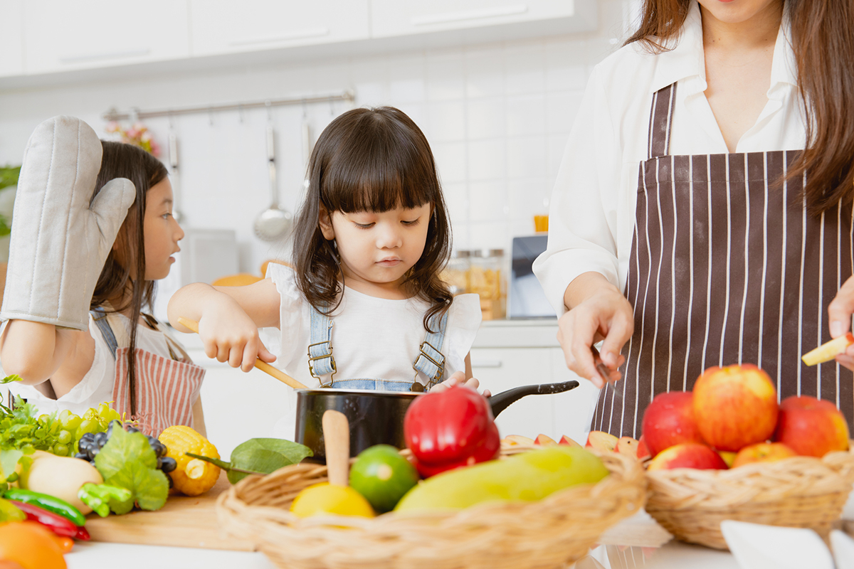 Daughters preparing ingredients with Mom
