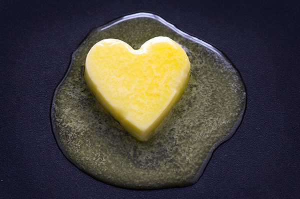 butter heart melting on dark background