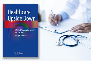 Book cover for Healthcare Upside Down by Henry Buchwald, MD, PhD, over a background image of a doctor writing on a clipboard, a stethoscope resting beside it