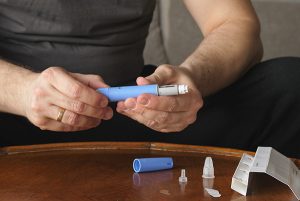 Heavy-set man preparing semaglutide injection