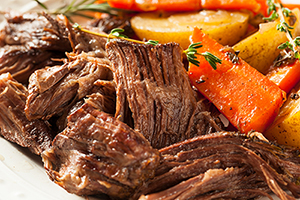 Close up view of beef pot roast with potatoes and carrots