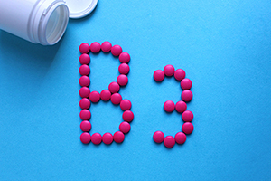 Blue background with a white pill bottle in the top left corner. Pink tablets spell out "B3"