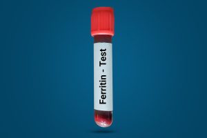 Blood vial labeled with "Ferritin - Test" over a dark gradient background.