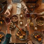 Above view background of multi-ethnic group of people enjoying feast during dinner party with friends and family