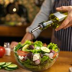 Pouring olive oil onto a salad