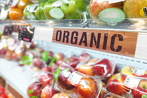 Organic food signage on modern supermarket fresh produce fruits aisle to appeal to healthy lifestyle shoppers