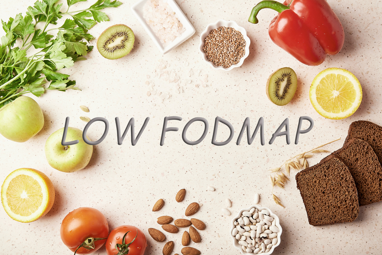 Low FODMAP concept with text in center. Low diet - fruits,vegetables, greenery, nuts, beans, flax seeds, chia seeds, wholegrain bread. Flat lay.