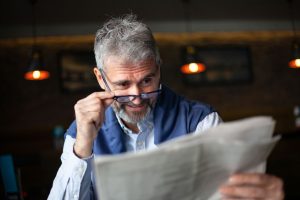 Senior man with newspaper drinking coffee, morning coffee