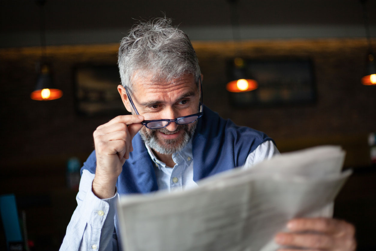 Senior man with newspaper drinking coffee, morning coffee