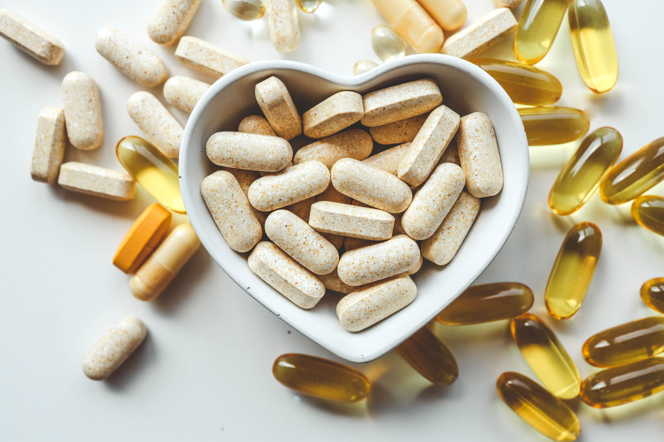 Tablets and vitamins on white background, banner advertising, pharmaceuticals.