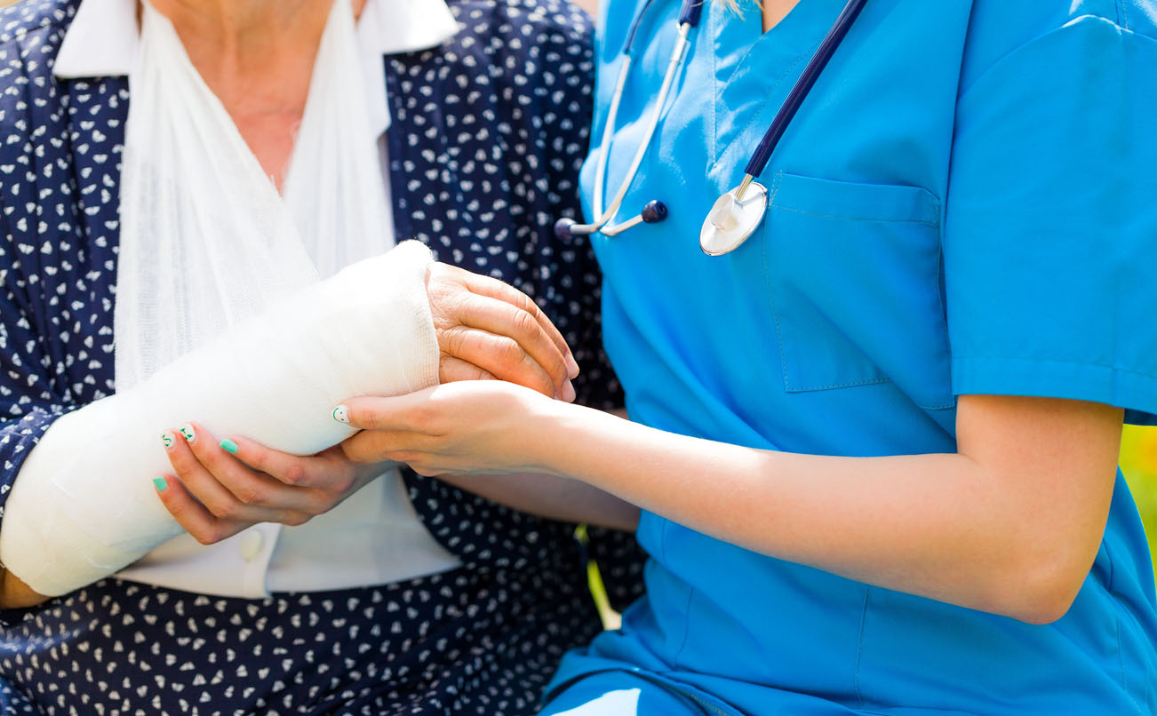 Closeup of supporting nurse hand for recuperate painful injury of the elderly.