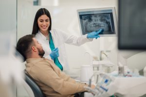 Dentist showing x-ray results to patient