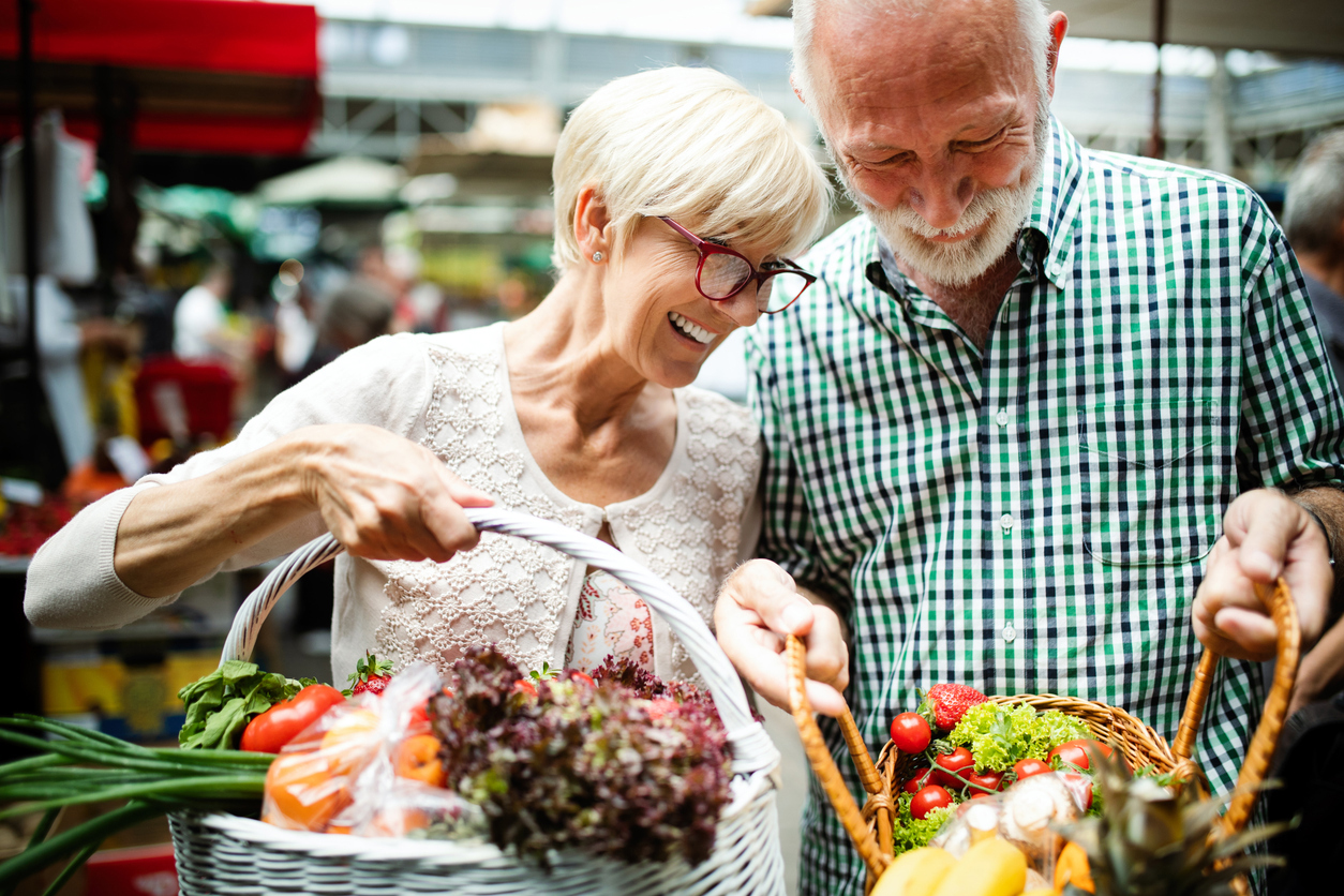 Senior couple shopping vegetables and fruits at the market