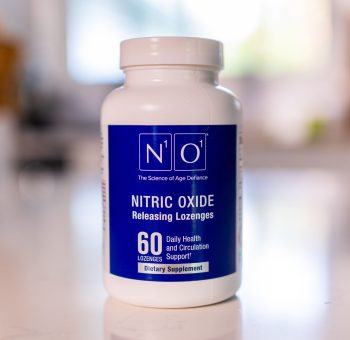Front view of a bottle of N1O1 nitrous oxide lozenges on a light colored stone countertop